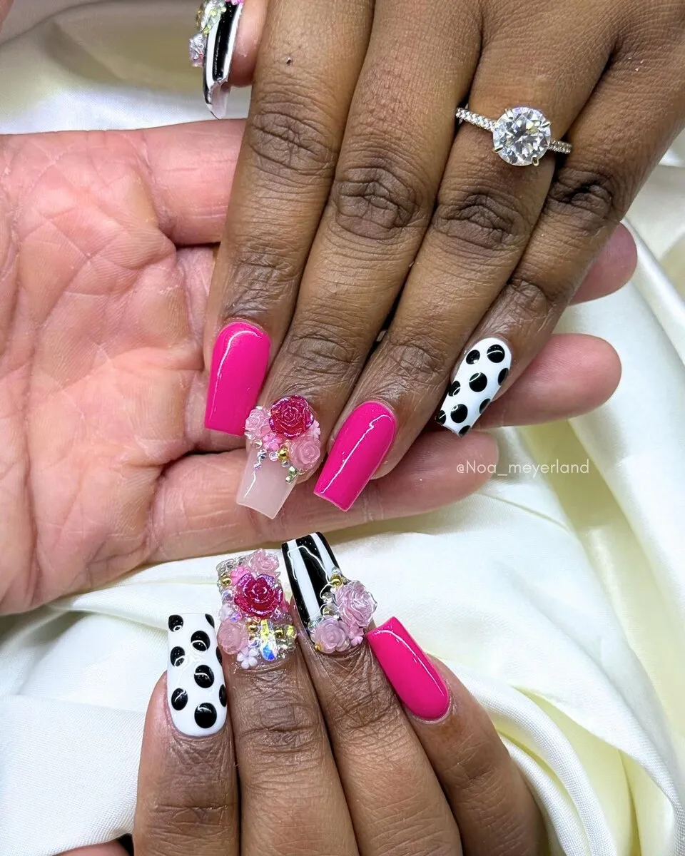 Long hot-pink coffin nails with black-and-white cow-print accent art