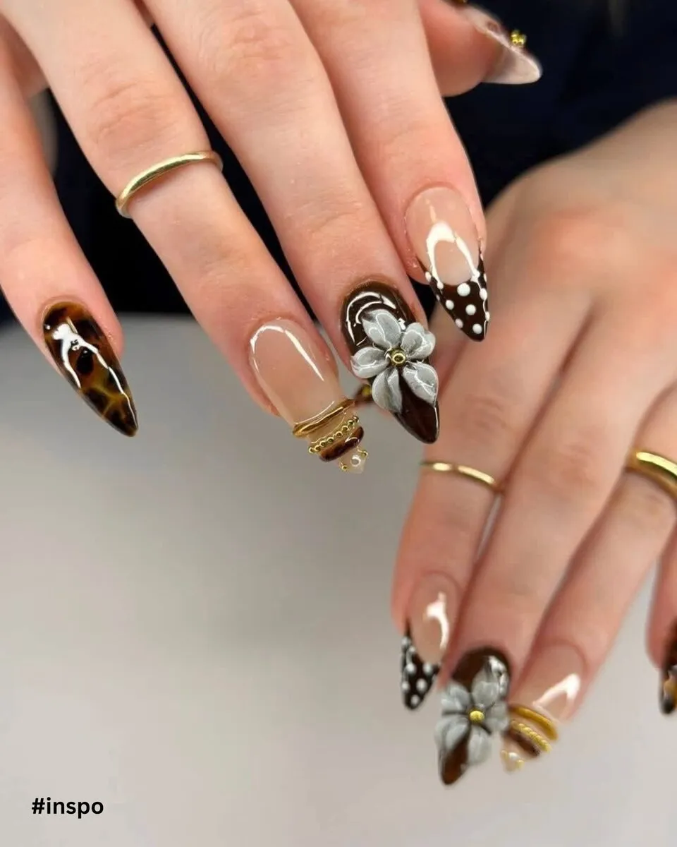 Black and gold stiletto nails with butterfly and abstract art