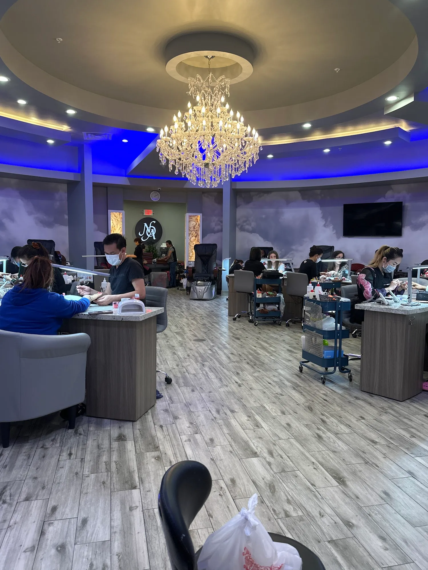 Crystal chandelier above the manicure floor at Nails of America Meyerland