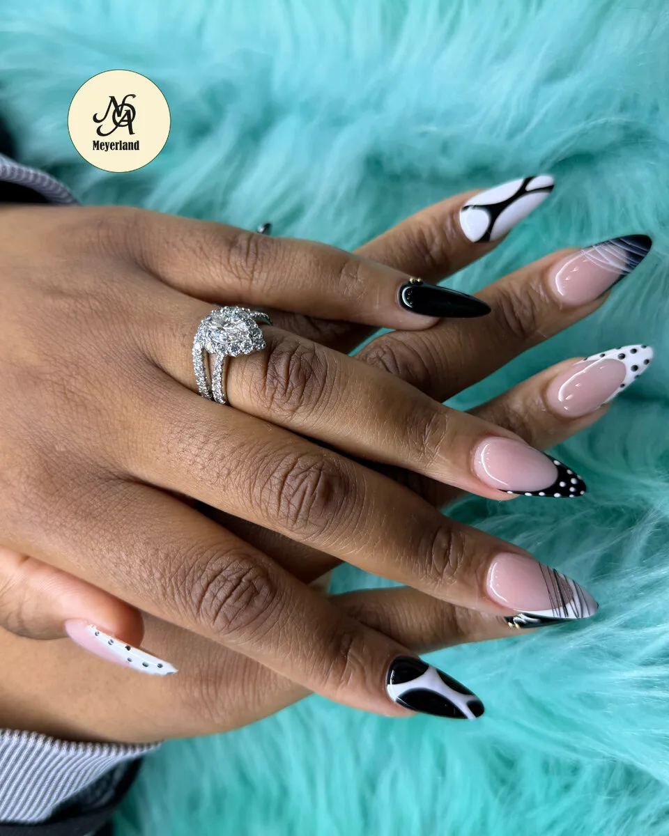 Black-and-white cow-print stiletto nails — a bold statement set