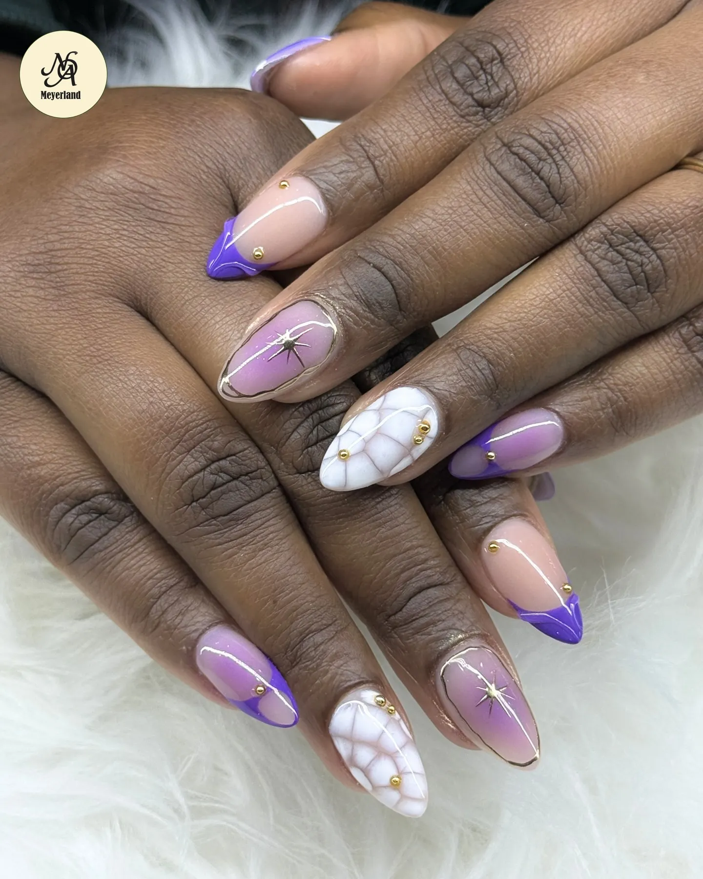 Purple French-tip almond nails with marble and gold detail