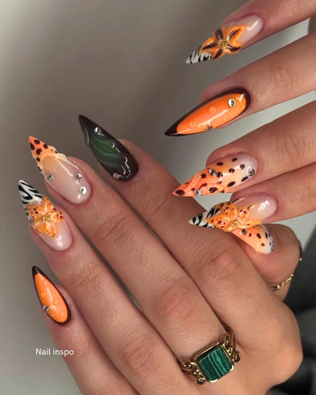 Autumn-toned almond nails with butterfly and animal print art