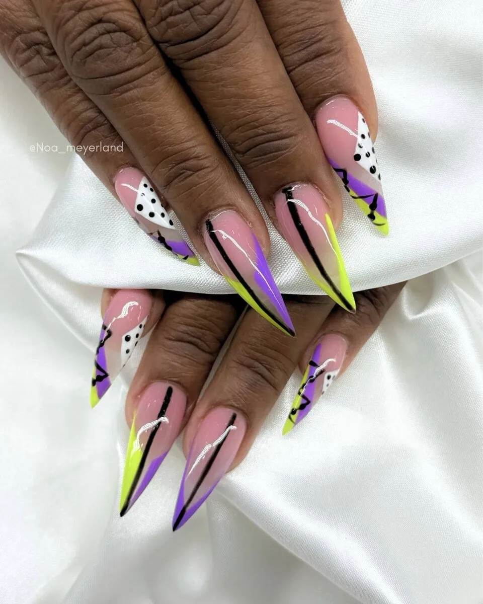 Long stiletto nails with neon-lime French tips and black swirl art