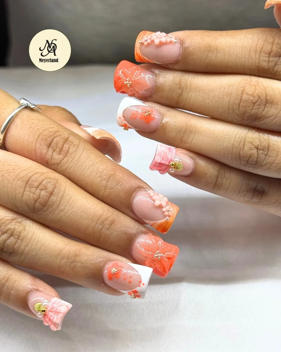 Orange and white French coffin nails with 3D floral accents